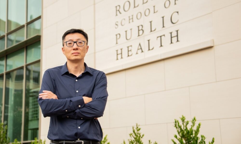 Yang Liu standing in front of the Rollins School of Public Health